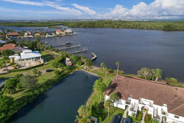 an aerial view of a house with a garden and lake view