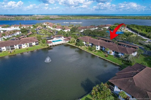 an aerial view of residential houses with outdoor space and river