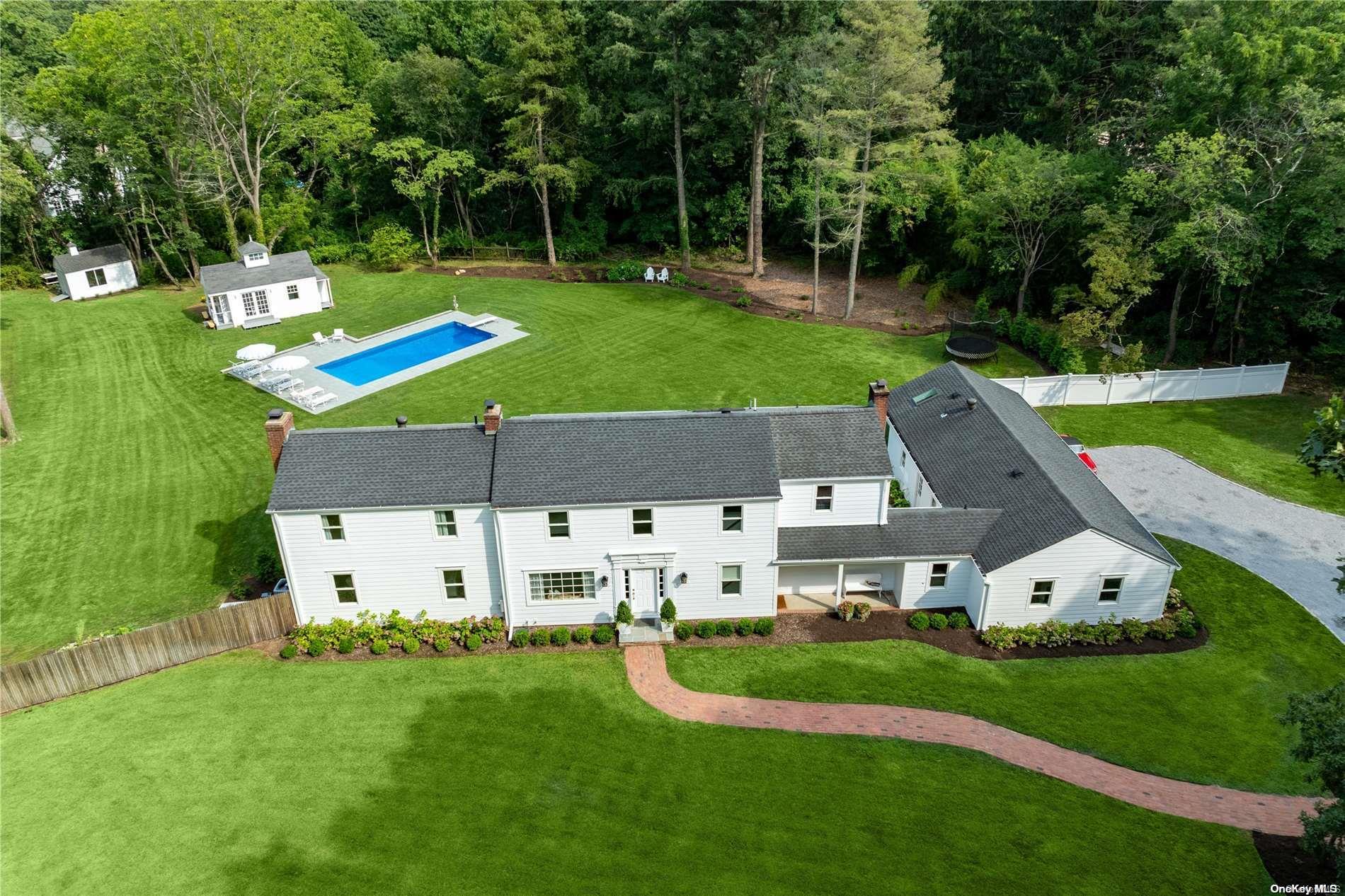 a aerial view of a house with swimming pool garden and green space