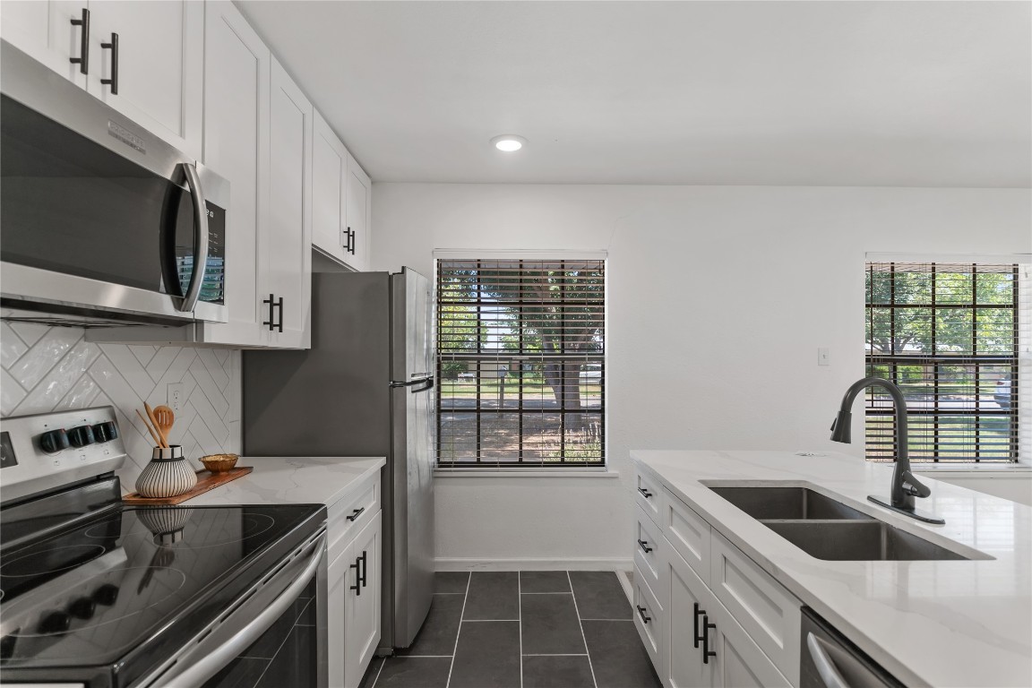 607 Magnolia Street Bastrop, TX 78602 - Photo 15 of 25 a kitchen with a sink a stove and cabinets