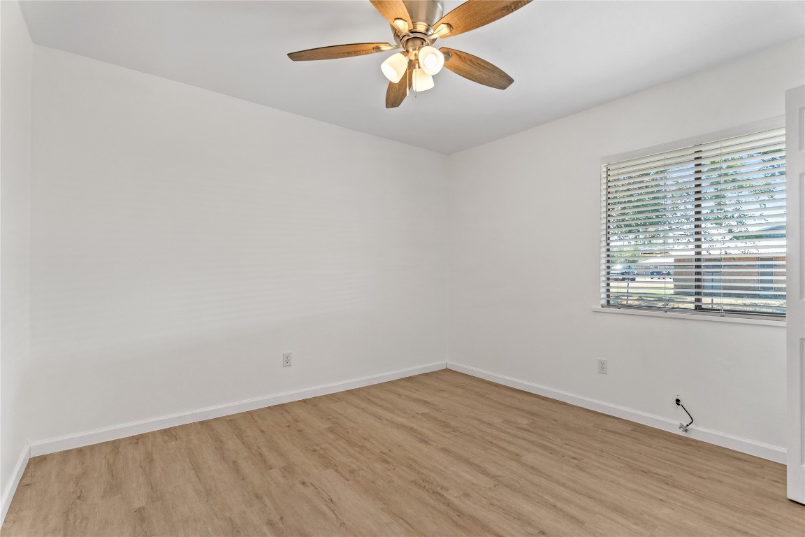 607 Magnolia Street Bastrop, TX 78602 - Photo 17 of 25 wooden floor in an empty room with a window