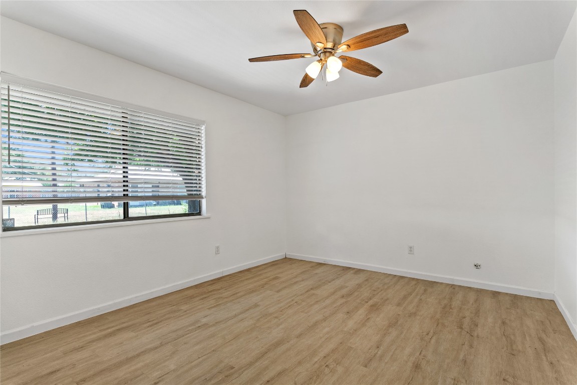 607 Magnolia Street Bastrop, TX 78602 - Photo 19 of 25 an empty room with a window and a ceiling fan
