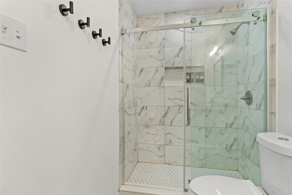 607 Magnolia Street Bastrop, TX 78602 - Photo 22 of 25 a bathroom with a shower toilet and sink