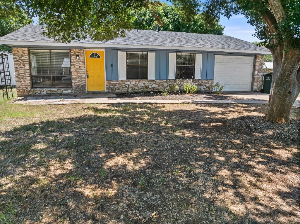 607 Magnolia Street Bastrop, TX 78602 - Photo 4 of 25 a front view of a house with a yard and potted plants