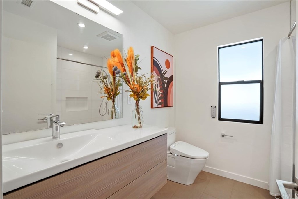 361 Aster Street Laguna Beach, CA 92651 - Photo 15 of 25 a bathroom with a toilet sink and mirror