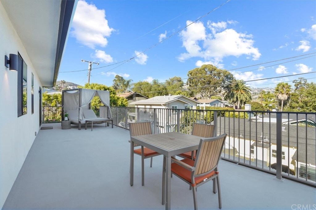 361 Aster Street Laguna Beach, CA 92651 - Photo 21 of 25 a view of a balcony with furniture and a floor to ceiling window