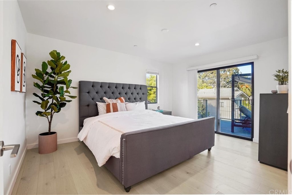 361 Aster Street Laguna Beach, CA 92651 - Photo 23 of 25 a bedroom with a large bed and a potted plant