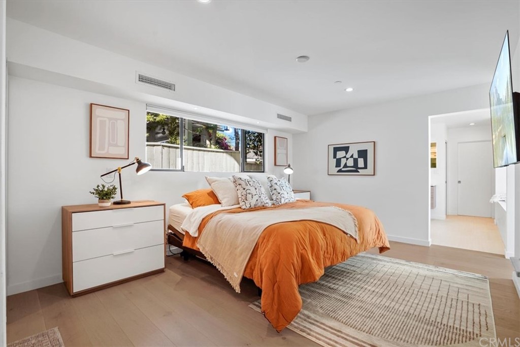361 Aster Street Laguna Beach, CA 92651 - Photo 10 of 25 a spacious bedroom with a bed and a couch