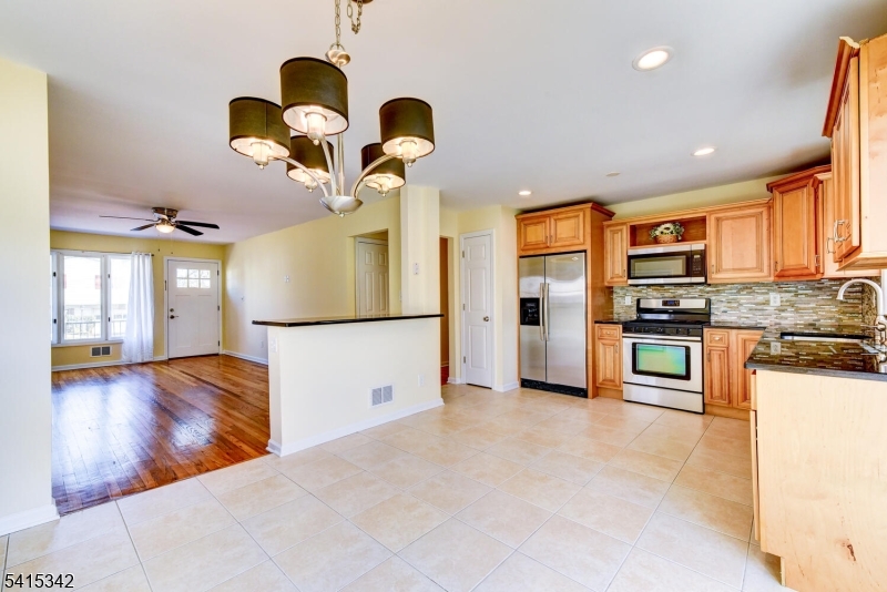 3 Michael Lane Somerville, NJ 08876 - Photo 11 of 31 a kitchen with stainless steel appliances granite countertop a refrigerator a oven a sink with island and chairs