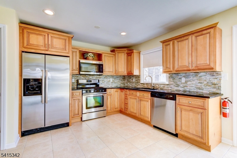 3 Michael Lane Somerville, NJ 08876 - Photo 13 of 31 a kitchen with stainless steel appliances granite countertop a refrigerator and a stove top oven