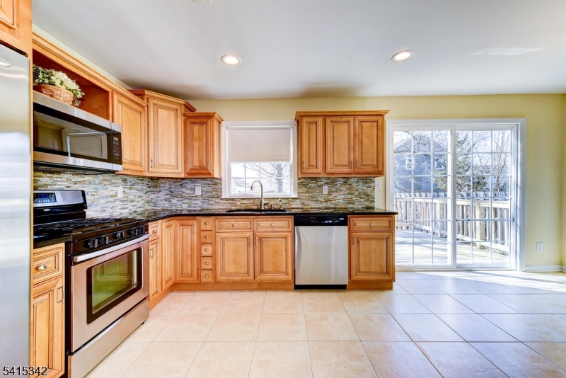 3 Michael Lane Somerville, NJ 08876 - Photo 15 of 31 a kitchen with stainless steel appliances granite countertop a stove a sink and a microwave