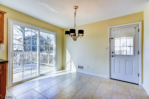 a view of a room with wooden floor and windows
