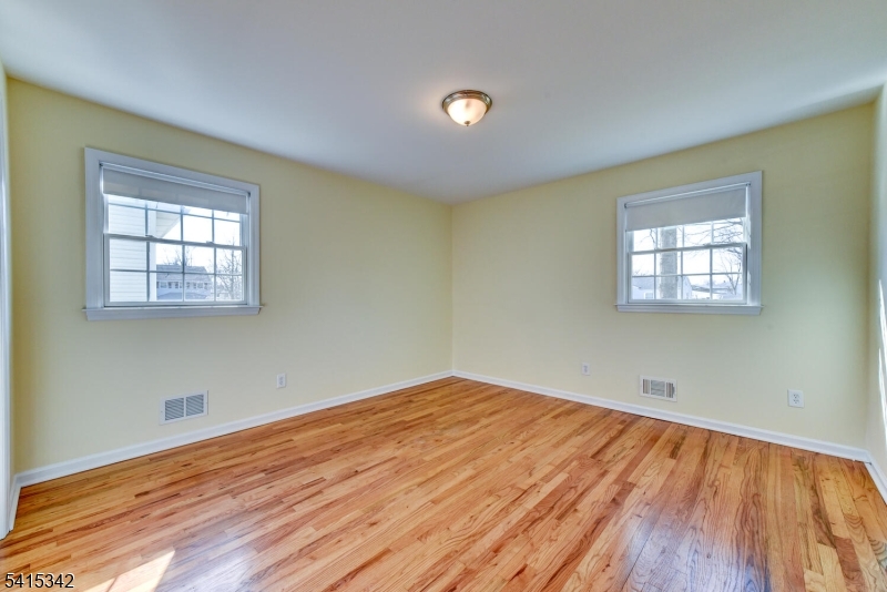 3 Michael Lane Somerville, NJ 08876 - Photo 20 of 31 a view of empty room with wooden floor and fan