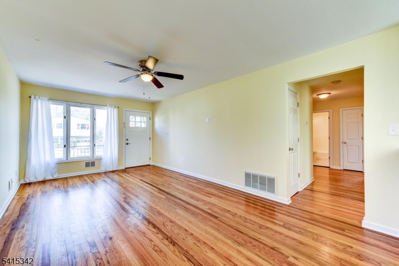3 Michael Lane Somerville, NJ 08876 - Photo 9 of 31 a view of empty room with wooden floor and fan