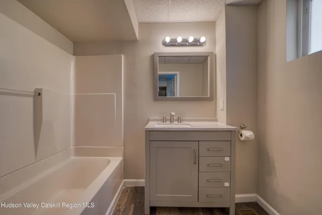 a bathroom with a sink a vanity and a bathtub
