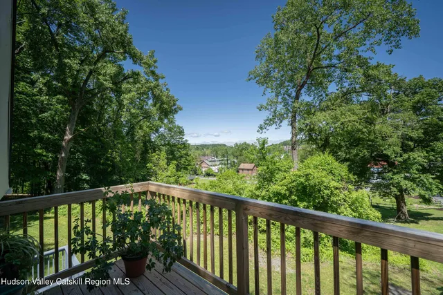a view of a balcony with wooden floor