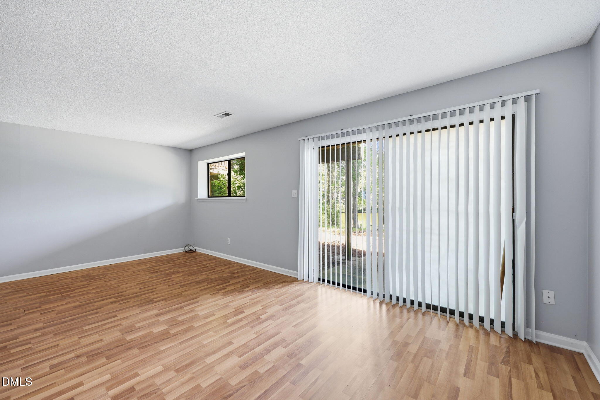 5043 Tall Pines Court Raleigh, NC 27609 - Photo 28 of 37 a view of an empty room with wooden floor and a window