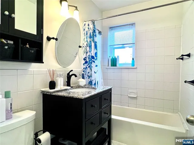a bathroom with a sink a toilet and a mirror