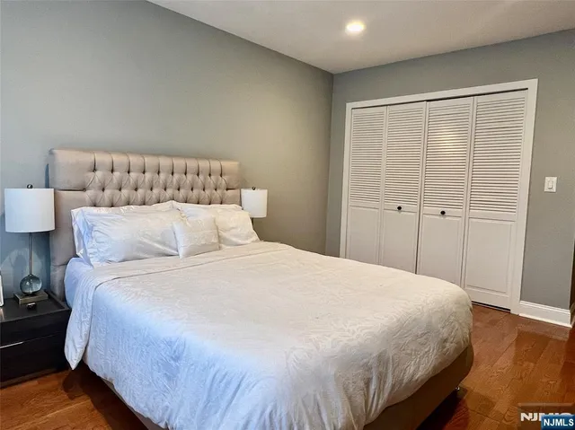 a large bed sitting in a bedroom next to a cabinet