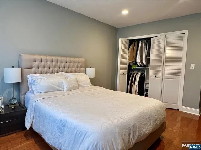 a large bed sitting in a bedroom next to a window