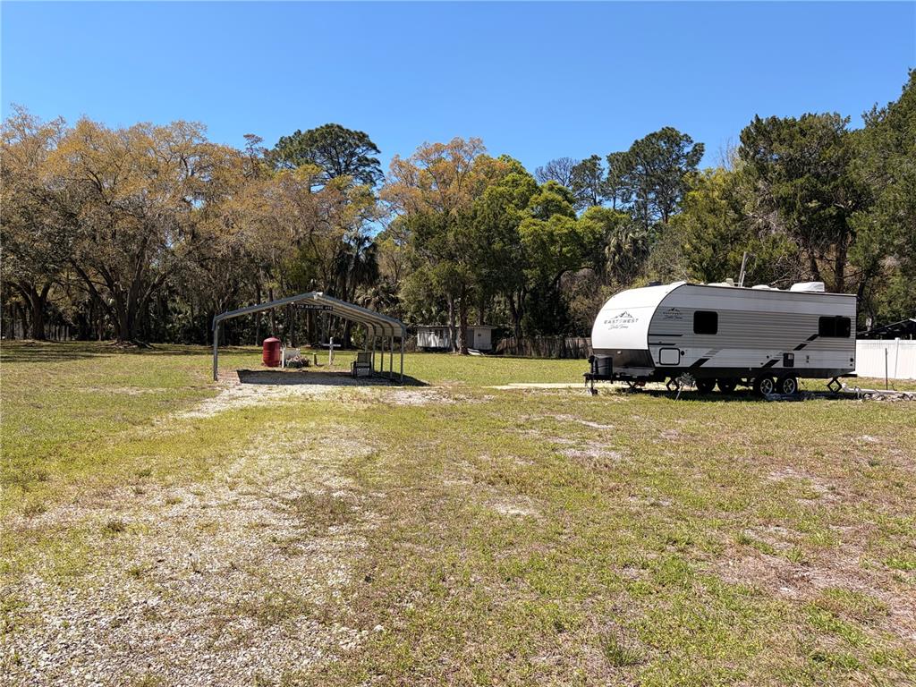 276 Marjorie Street Inglis, FL 34449 - Photo 4 of 5 a swimming pool with trees in the background