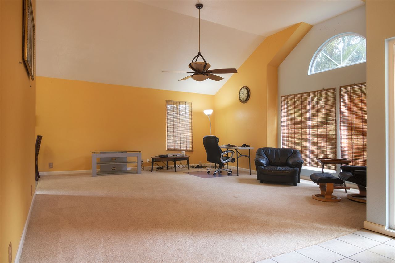 1016 East Kuiaha Road Haiku, HI 96708 - Photo 8 of 21 a living room with furniture and a chandelier