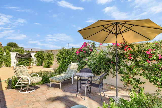 a front view of house with yard and outdoor seating