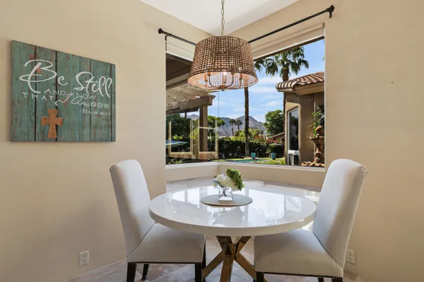 a view of a dining room with furniture and a chandelier