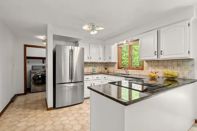 a kitchen with a refrigerator a sink and cabinets