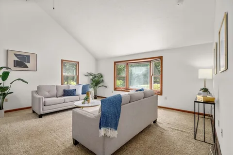 a living room with furniture and a lamp