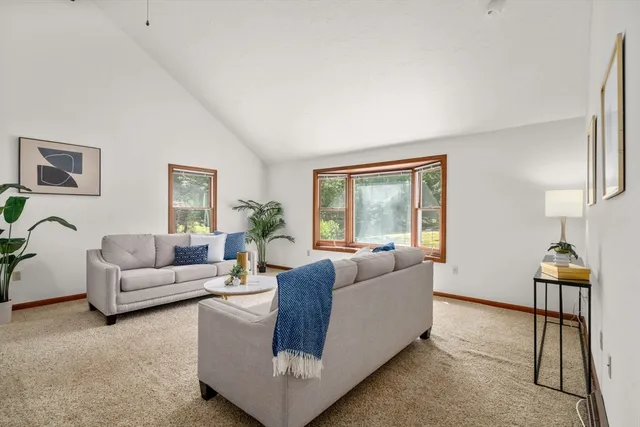 a living room with furniture and a lamp