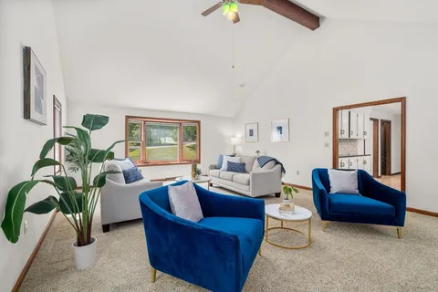 a living room with furniture and a potted plant
