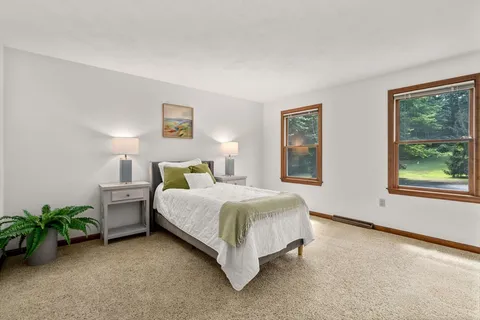 a spacious bedroom with a bed and a window