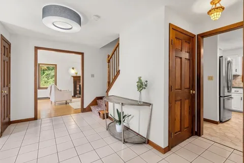 a view of an entryway with wooden floor