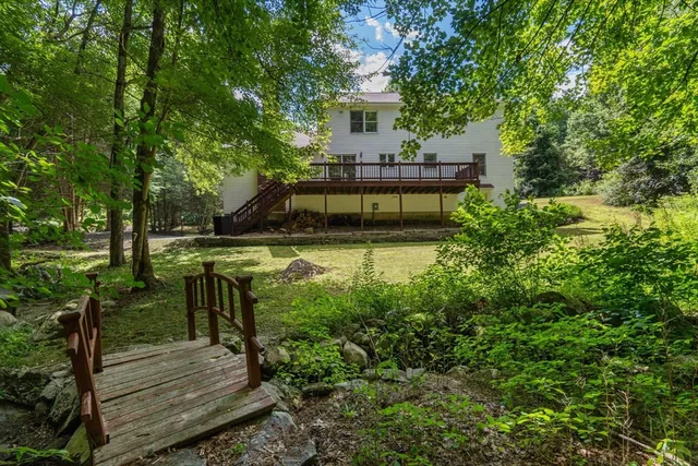 a view of a house with backyard and sitting area