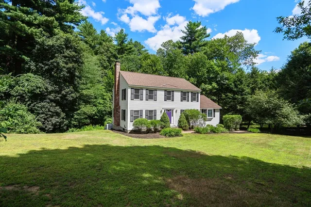 a view of house with yard and green space