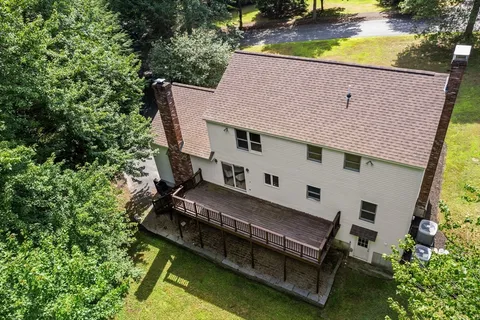a backyard of a house with table and chairs