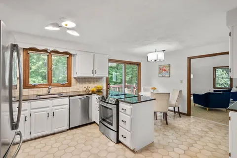 a kitchen with a sink stove and cabinets