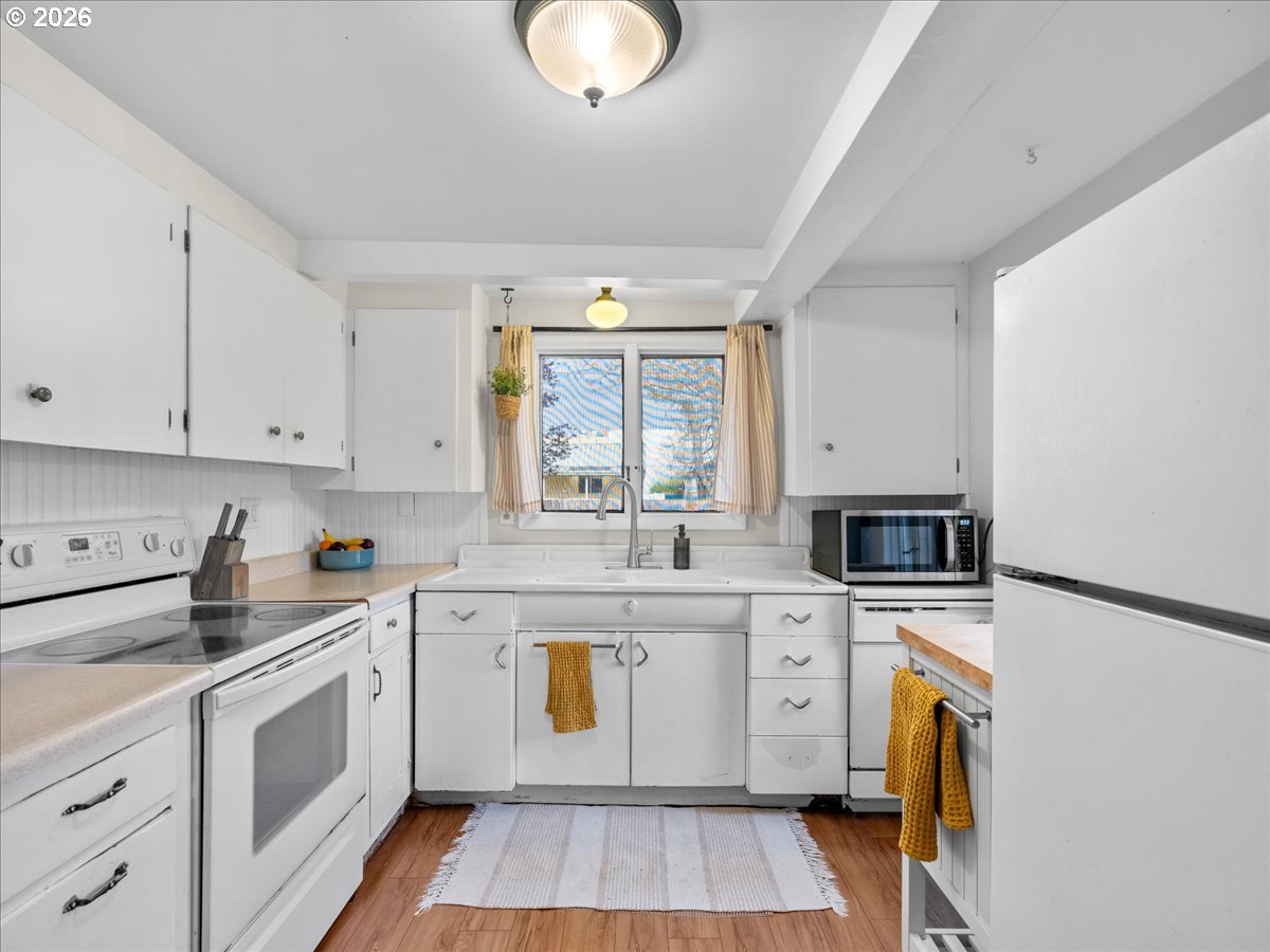 815 Shipping Street Northeast Salem, OR 97301 - Photo 21 of 45 a kitchen with a white cabinets and sink