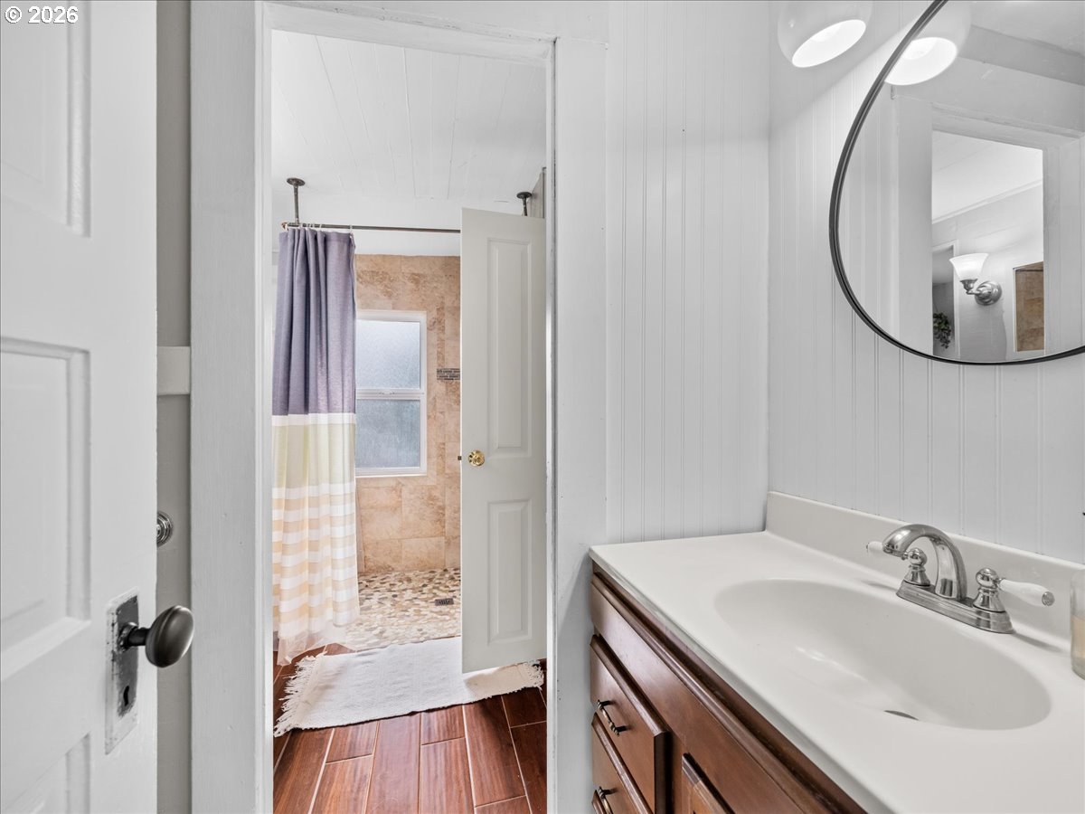 815 Shipping Street Northeast Salem, OR 97301 - Photo 24 of 45 a bathroom with a sink a mirror a vanity and a shower