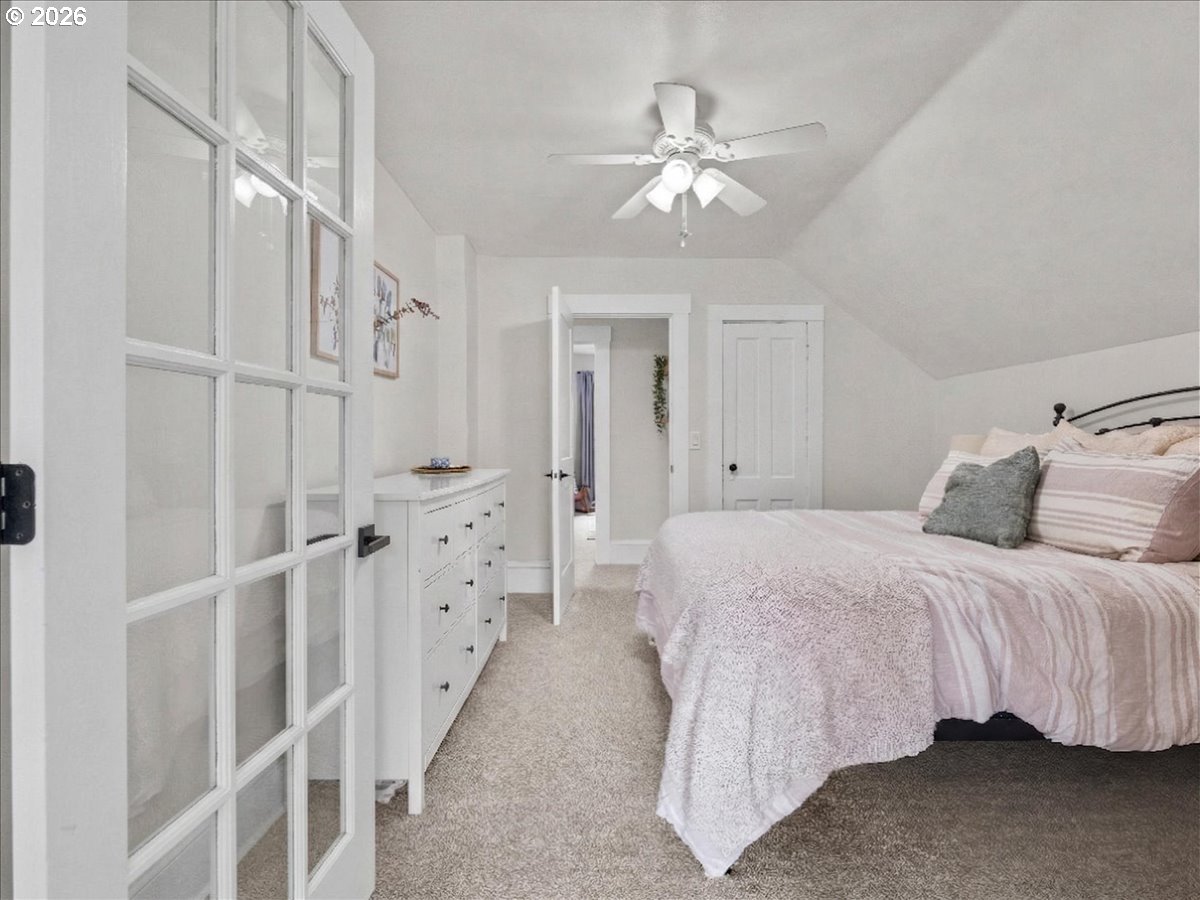 815 Shipping Street Northeast Salem, OR 97301 - Photo 33 of 45 a spacious bedroom with a bed and a chandelier