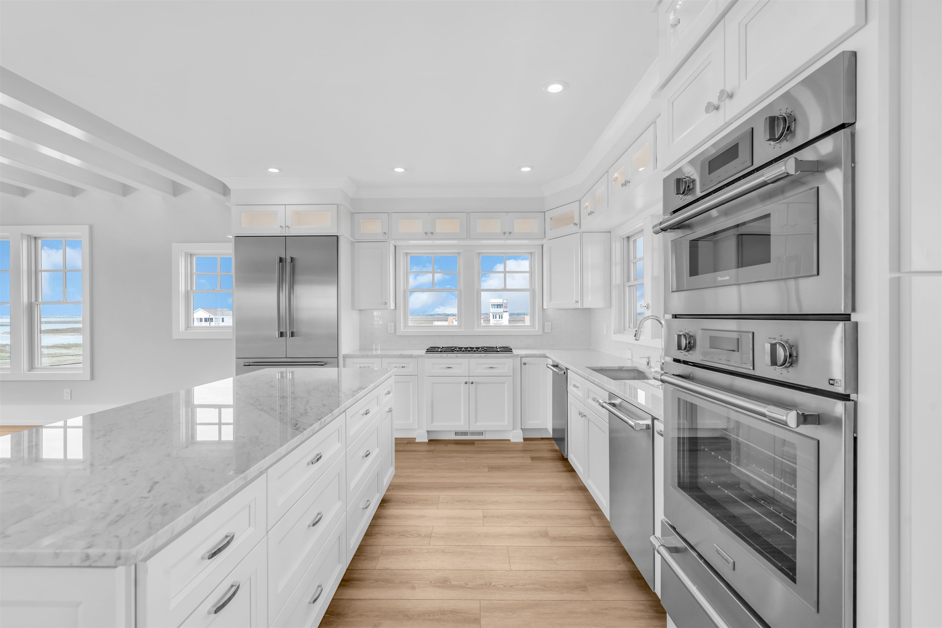 117 Taylor Strathmere, NJ 08248 - Photo 23 of 50 a large white kitchen with granite countertop a large counter top space appliances and cabinets