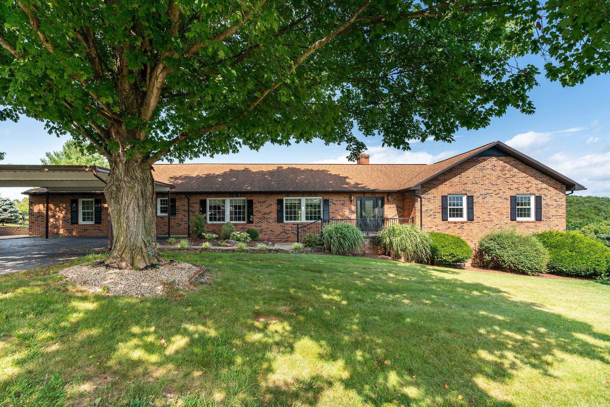 a front view of a house with a yard and porch