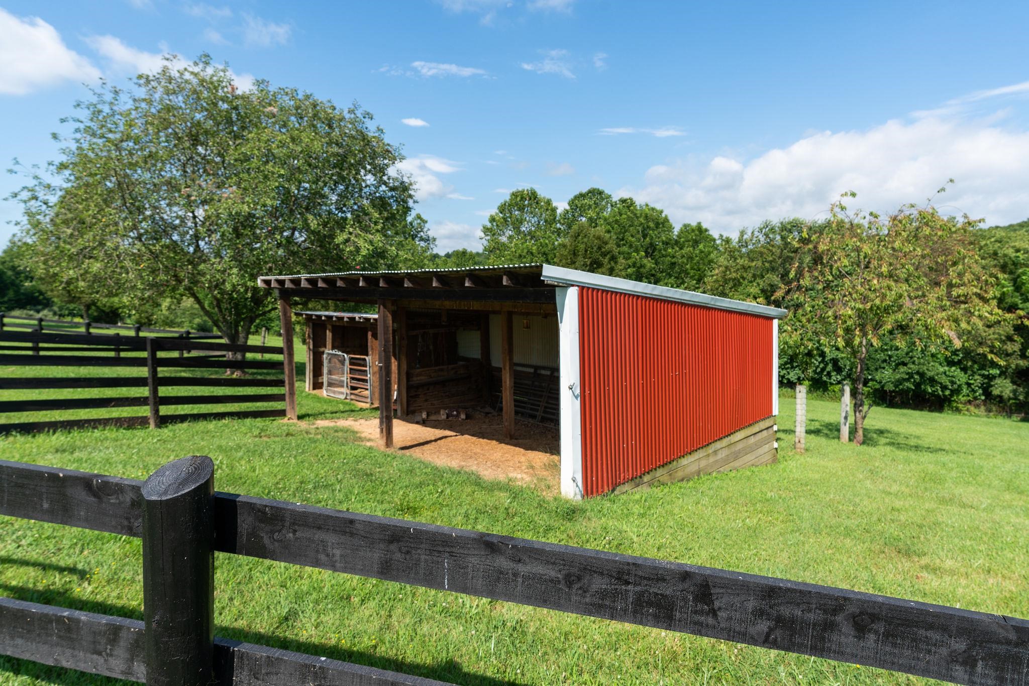 308 Stonewall Road Weyers Cave, VA 24486 - Photo 22 of 71 a view of a backyard with barn and a garden