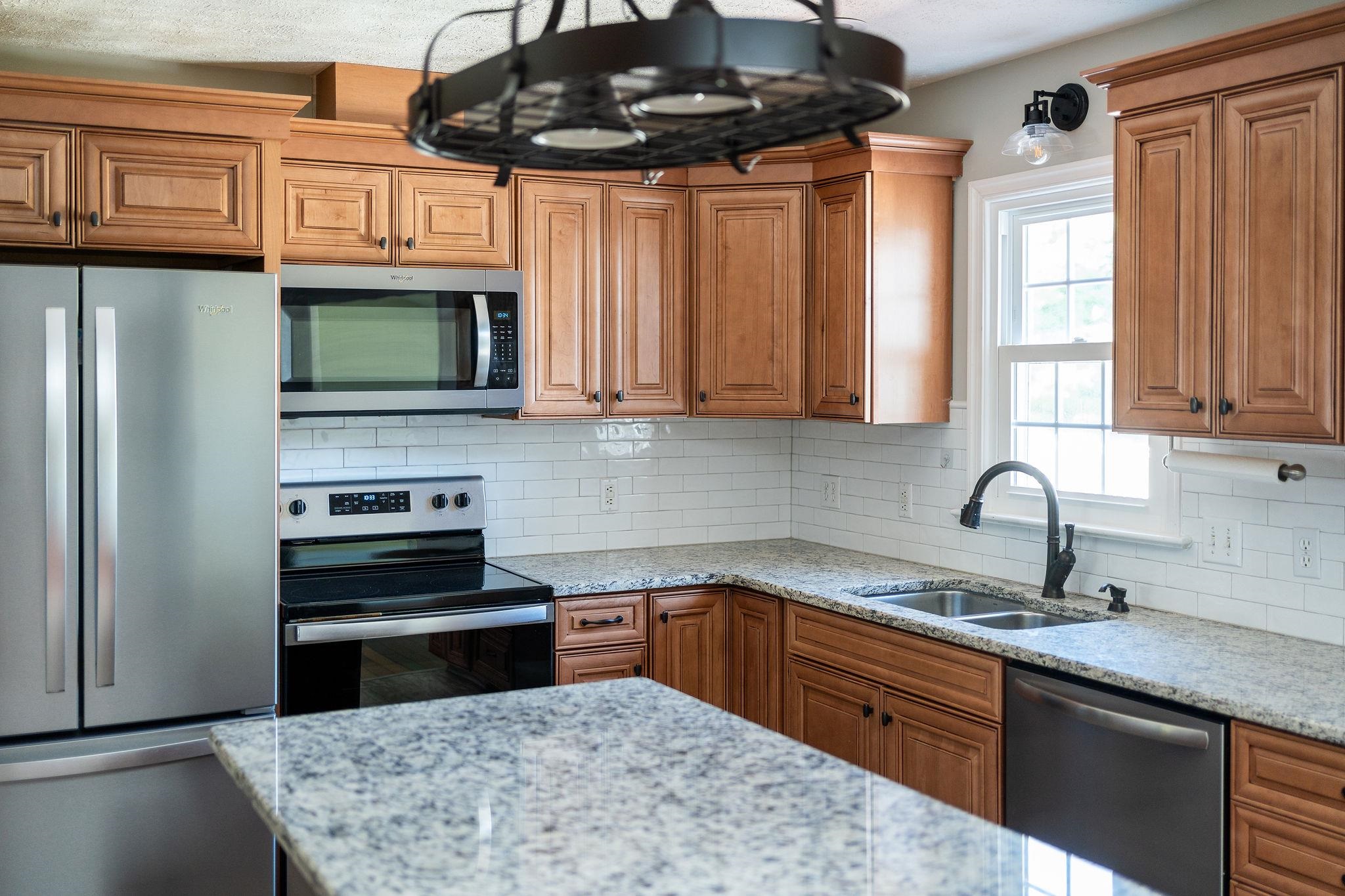 308 Stonewall Road Weyers Cave, VA 24486 - Photo 31 of 71 a kitchen with stainless steel appliances granite countertop a stove sink microwave and refrigerator