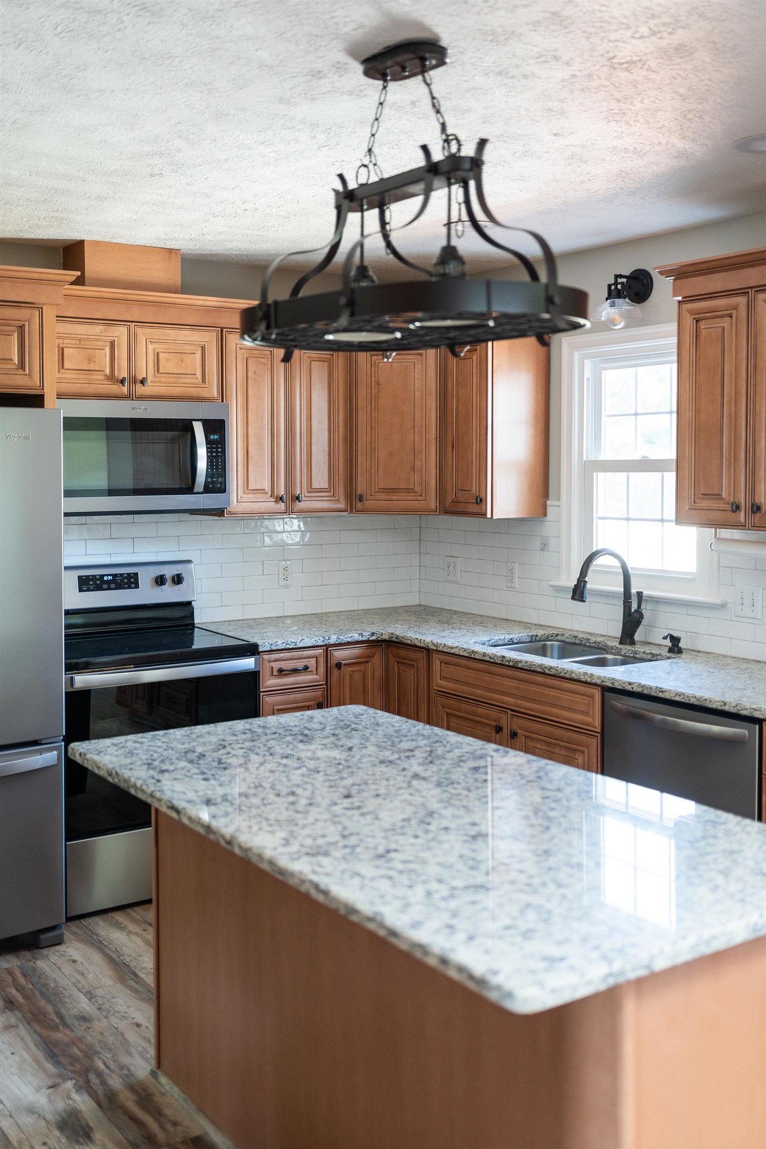 308 Stonewall Road Weyers Cave, VA 24486 - Photo 37 of 71 a kitchen with stainless steel appliances granite countertop a sink a stove and a microwave