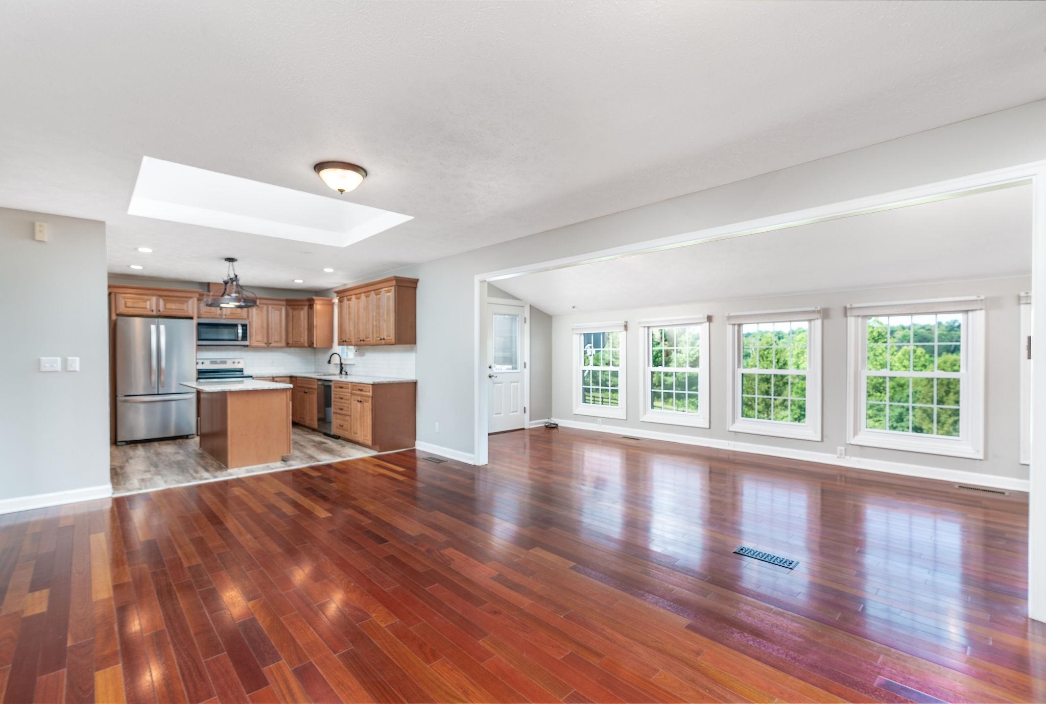 308 Stonewall Road Weyers Cave, VA 24486 - Photo 39 of 71 a view of a kitchen and an empty room with wooden floor and a kitchen
