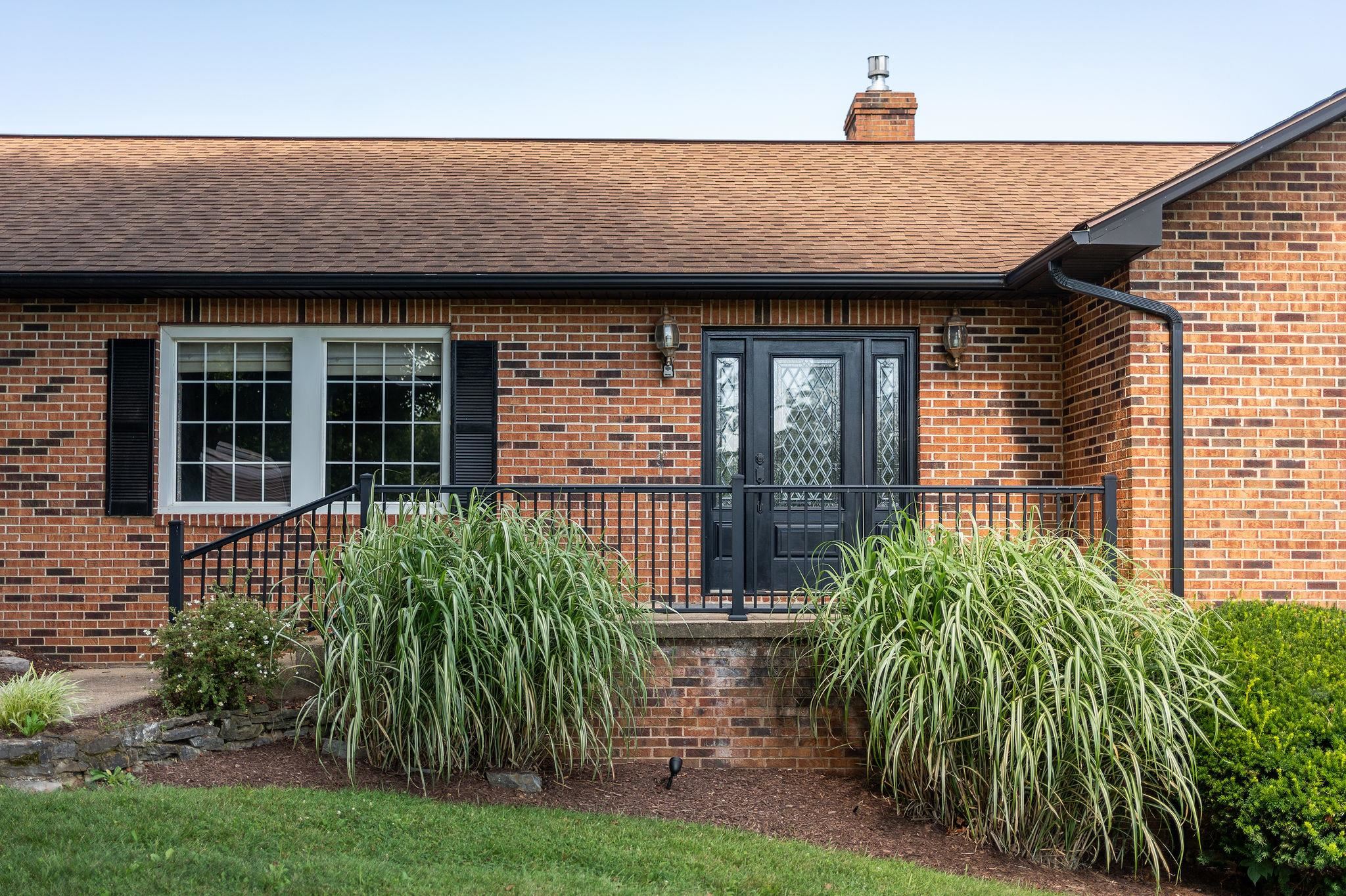 308 Stonewall Road Weyers Cave, VA 24486 - Photo 4 of 71 a front view of a house with a garden