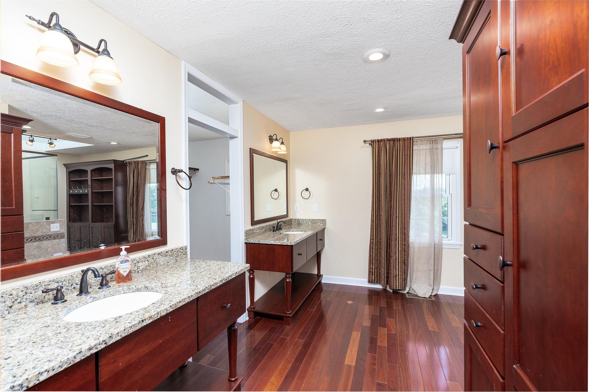 308 Stonewall Road Weyers Cave, VA 24486 - Photo 44 of 71 a spacious bathroom with a granite countertop sink a mirror and shower