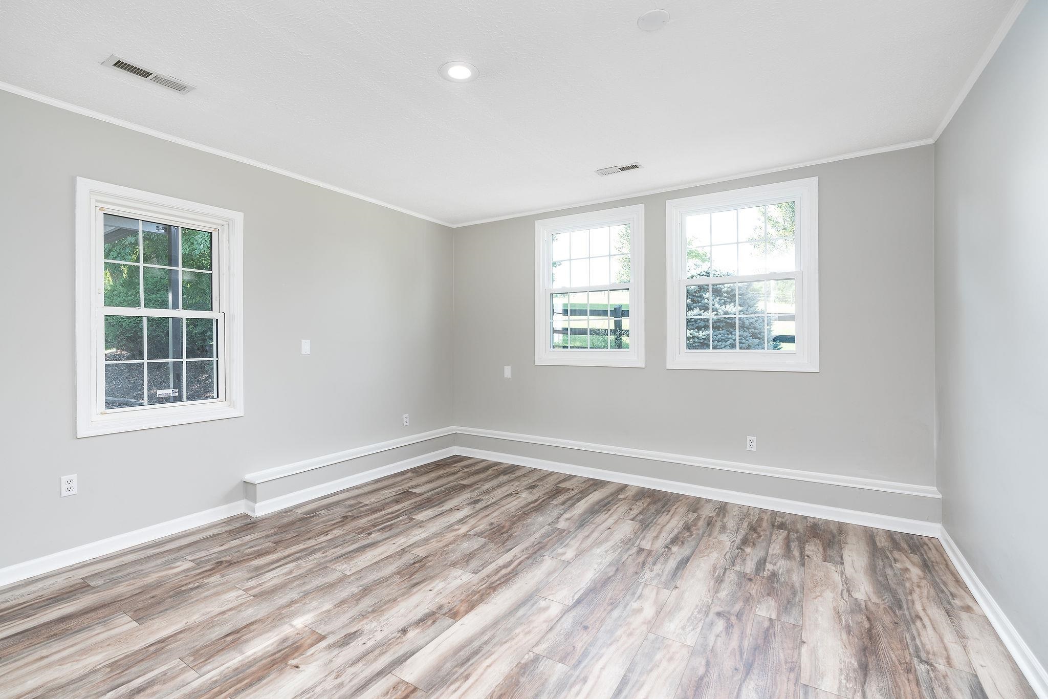 308 Stonewall Road Weyers Cave, VA 24486 - Photo 65 of 71 a view of an empty room with wooden floor and a window